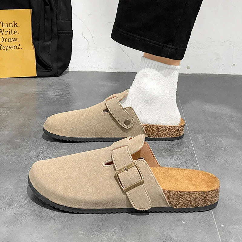 Casual slip-on clogs. Featuring a soft suede-like upper, contoured cork footbed, and an adjustable buckle strap