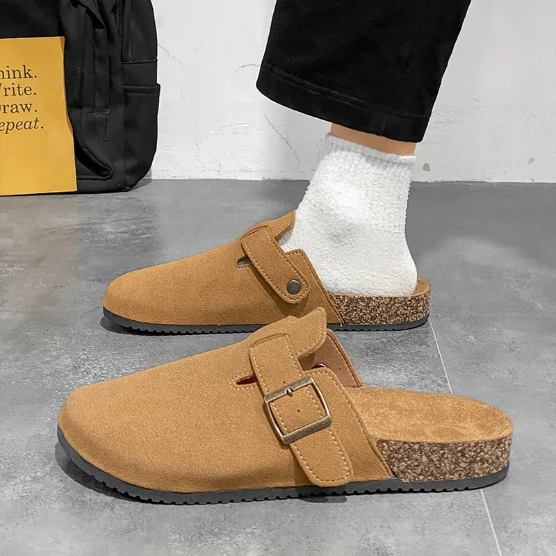 Casual slip-on clogs. Featuring a soft suede-like upper, contoured cork footbed, and an adjustable buckle strap