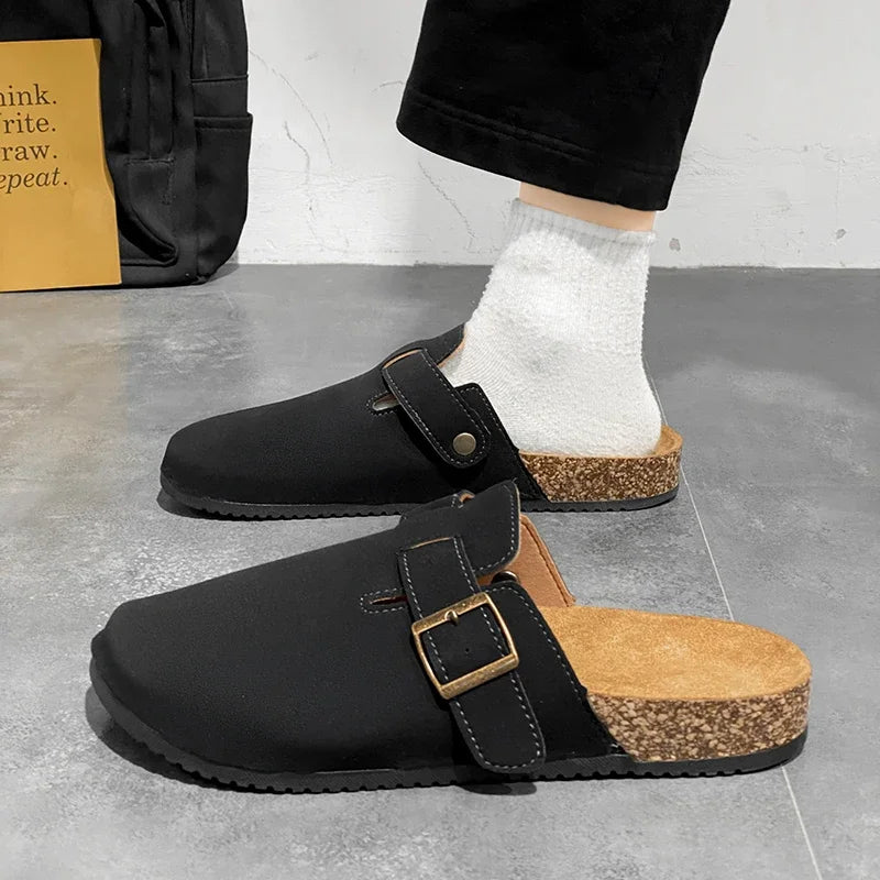 Casual slip-on clogs. Featuring a soft suede-like upper, contoured cork footbed, and an adjustable buckle strap