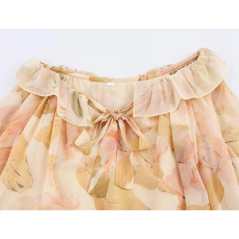 Boho-Chic Floral Pleated Two-Piece Set – Romantic Ruffle Blouse & Mini Skirt  Turn heads this season with our Boho-Chic Floral Pleated Two-Piece Set, a dreamy blend of elegance and carefree charm.