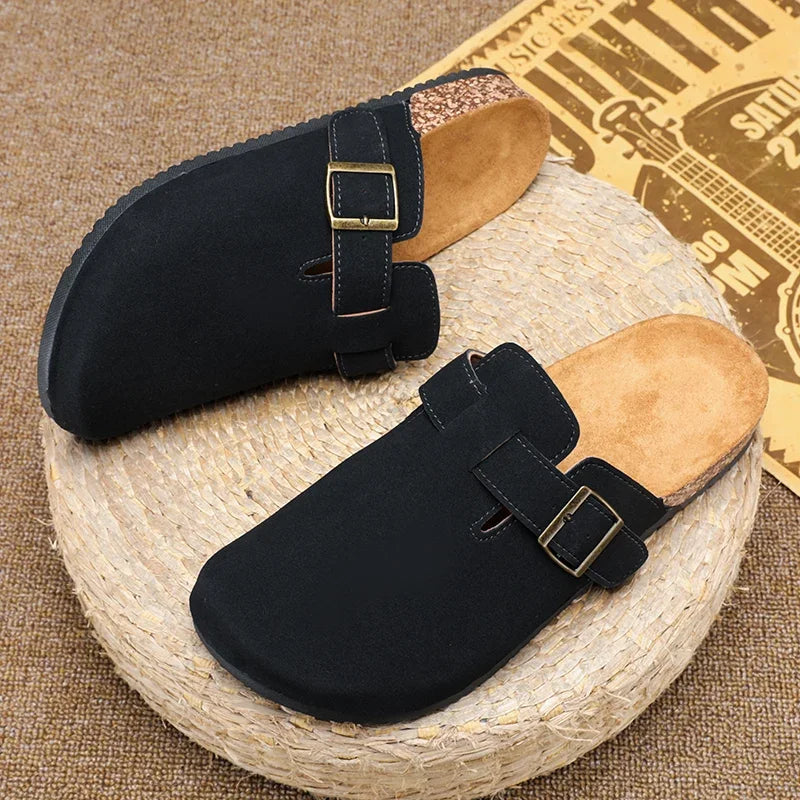 Casual slip-on clogs. Featuring a soft suede-like upper, contoured cork footbed, and an adjustable buckle strap