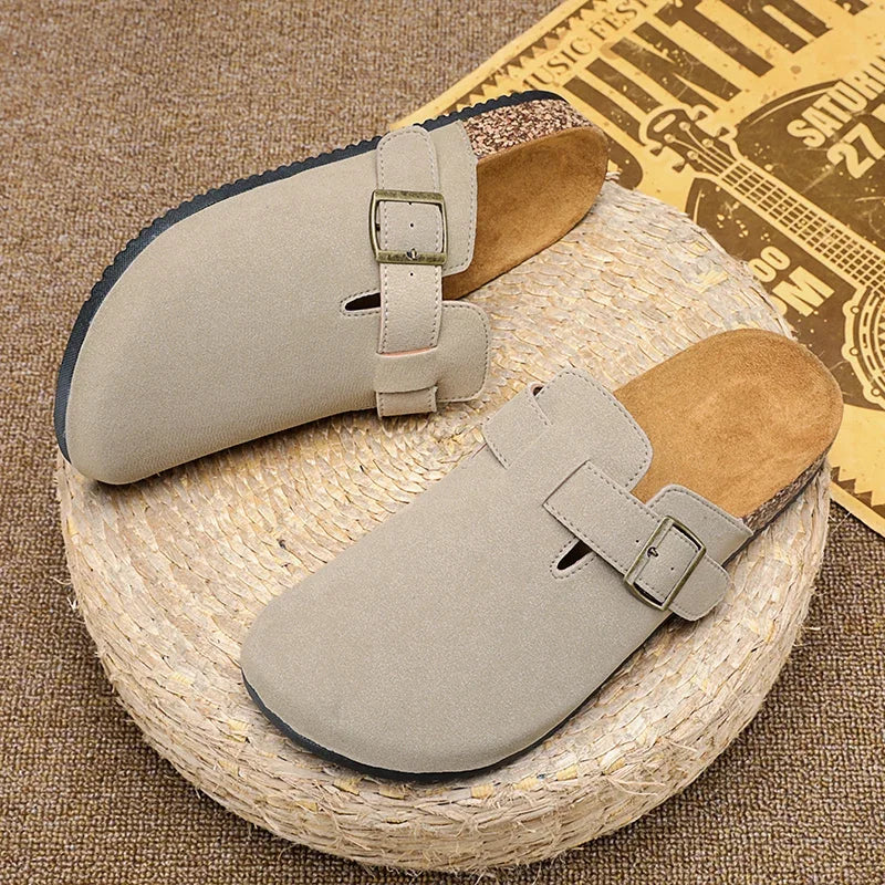 Casual slip-on clogs. Featuring a soft suede-like upper, contoured cork footbed, and an adjustable buckle strap