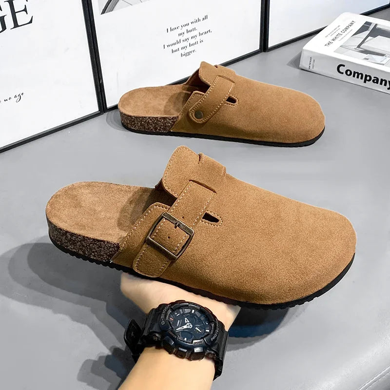 Casual slip-on clogs. Featuring a soft suede-like upper, contoured cork footbed, and an adjustable buckle strap